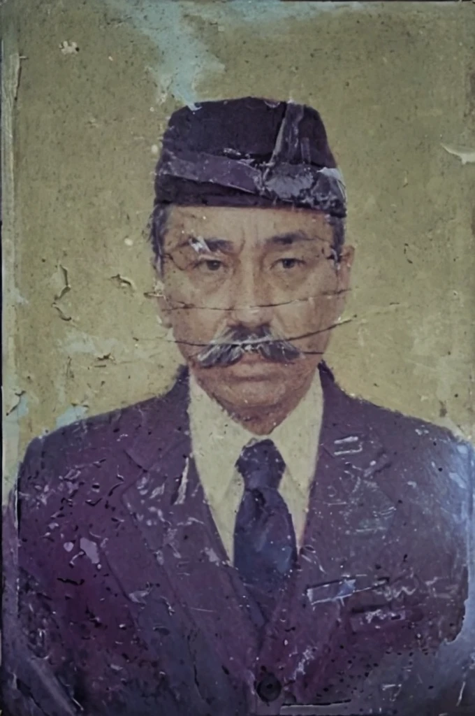 middle-aged man, with a mustache, wearing a black cap and suit