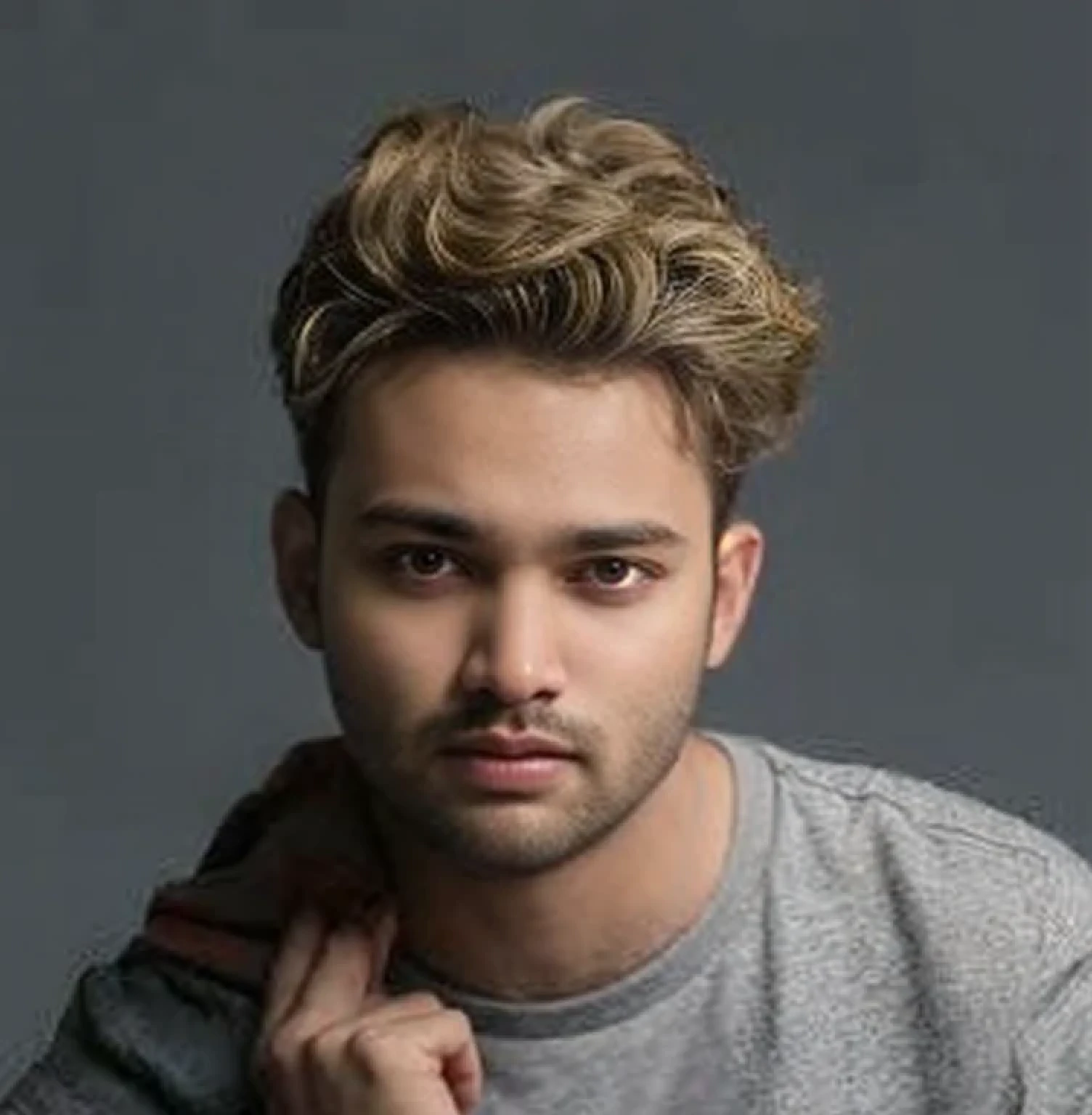 A beautiful young bearded man with highly detailed skin.quite expression 