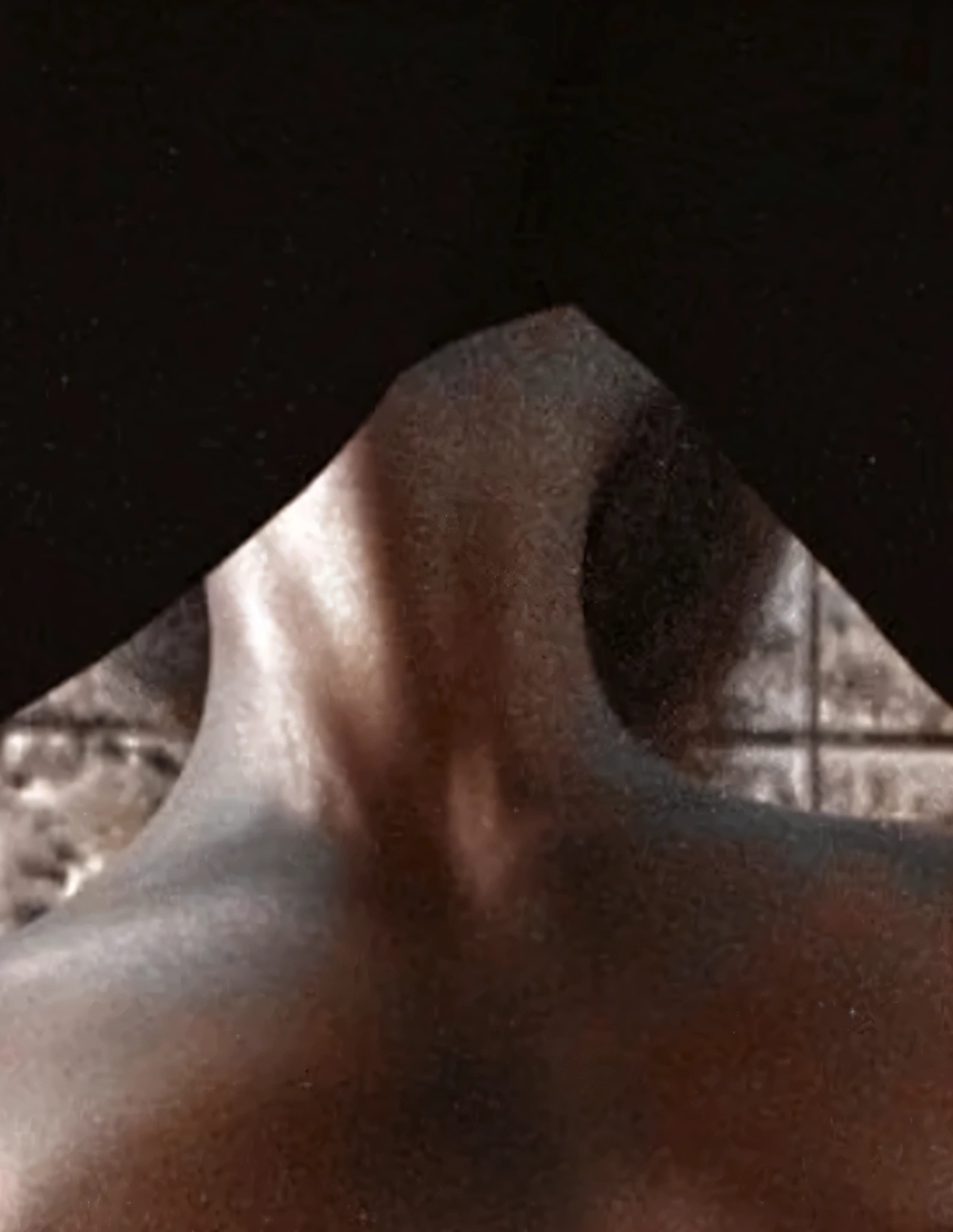 there is a man with a black shirt on and a black shirt on, neck zoomed in from lips down, neck zoomed in, neck visible, muscular neck, realistic flesh texture, white neck visible, detailed shot legs-up, extremely close shot, face partially obscured, bottom body close up, realistic shaded perfect , photorealistic skin texture