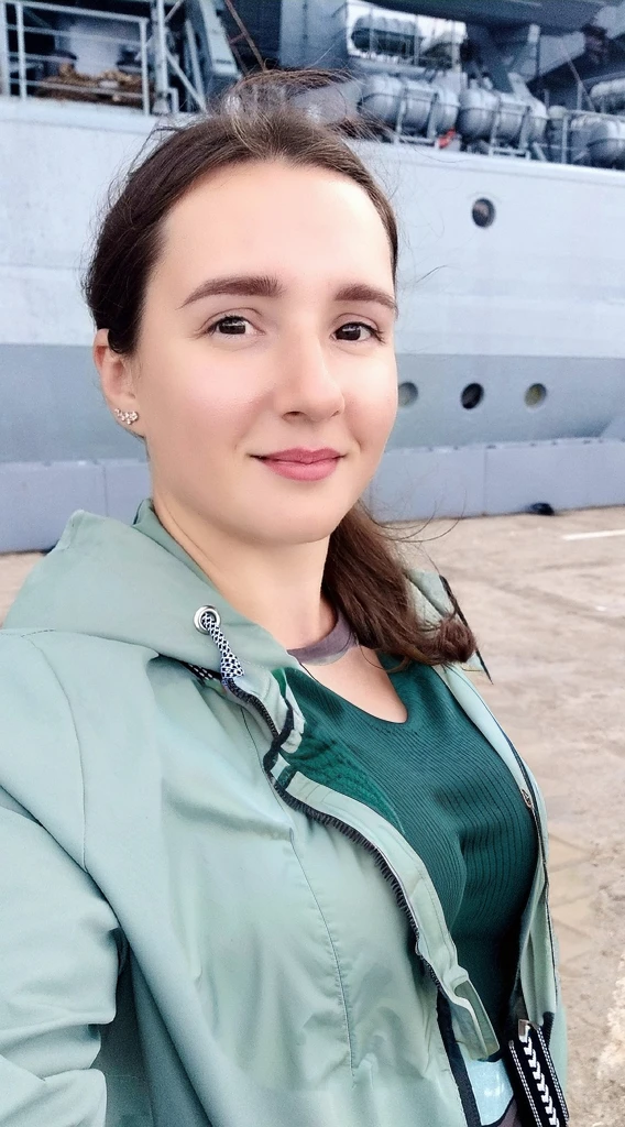 Arafed woman in a green jacket stands in front of a large ship, profile picture 1024px, naked tits, Girl with warship details, vacation photos, moleksandra shchaslyva, Photo portrait, profile picture, standing on the deck of a ship, Alexandra Valishevskaya, profile photo, anastasia ovchinnikova