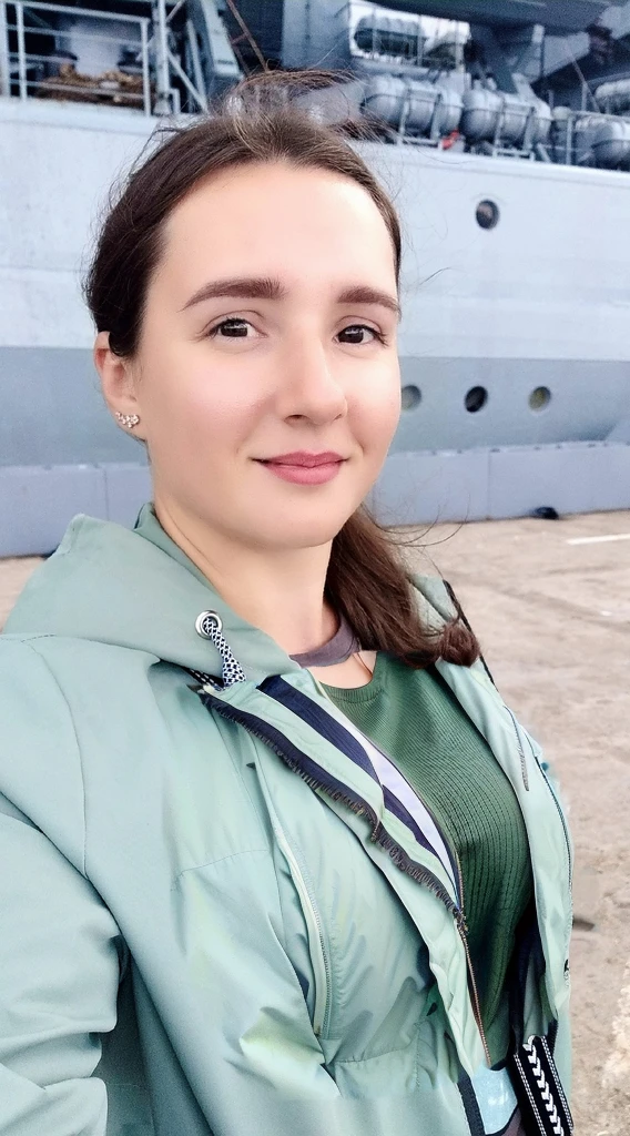 Arafed woman in a green jacket stands in front of a large ship, profile picture 1024px, naked tits, Girl with warship details, vacation photos, moleksandra shchaslyva, Photo portrait, profile picture, standing on the deck of a ship, Alexandra Valishevskaya, profile photo, anastasia ovchinnikova