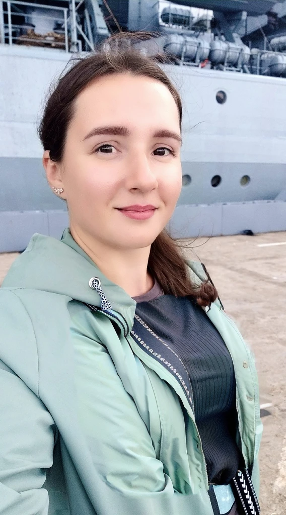 Arafed woman in a green jacket stands in front of a large ship, profile picture 1024px, naked tits, Girl with warship details, vacation photos, moleksandra shchaslyva, Photo portrait, profile picture, standing on the deck of a ship, Alexandra Valishevskaya, profile photo, anastasia ovchinnikova