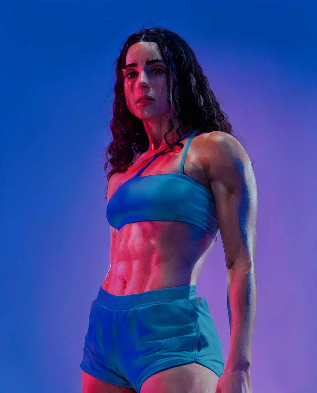 Woman, 27 yeats old, perfect abs, white skin (sweating after the dance workout), curly long hais (black hairs:1.4), (wearing fitness shorts and sport bra),