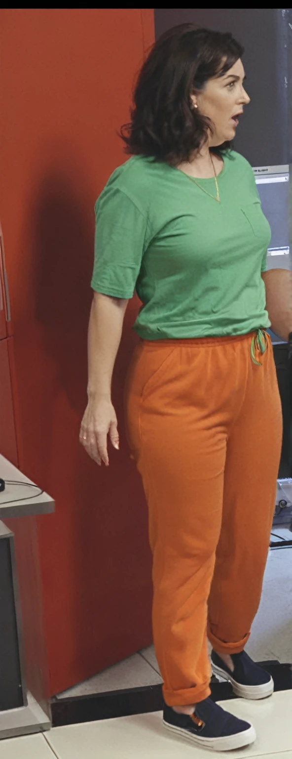 there is a woman standing in front of a computer screen, red shirt brown pants, wearing an orange t-shirt, wearing an orange t shirt, wearing pants and a t-shirt, middle shot waist up, wearing pants, wearing an orange jumpsuit, wearing orange prison jumpsuit, orange fluffy belly, vibrant but dreary orange, hand on hips, large pants