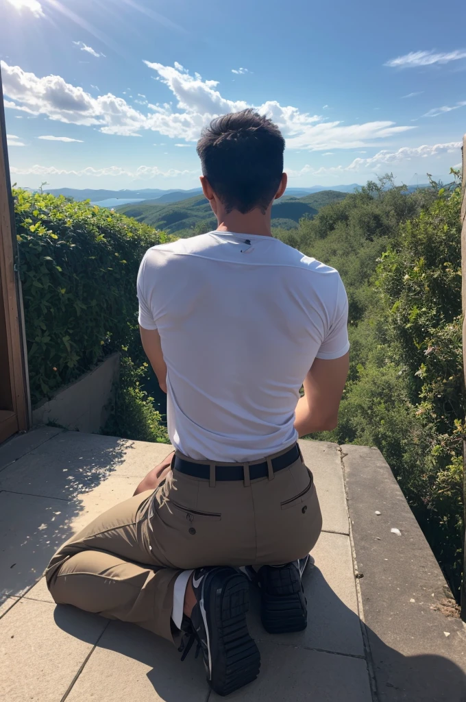A man with his back, Kneeling making a prayer. Showing the sky 