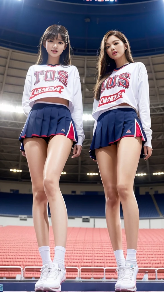 Close-up: Two tall, long-legged, big-breasted, shiny, cheerleading girls standing in the stadium, seen from below