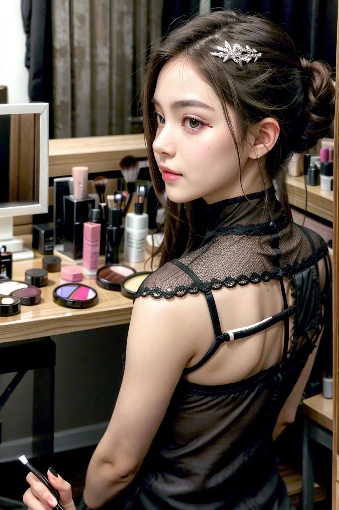 girl sitting behind makeup table, back to the camera 