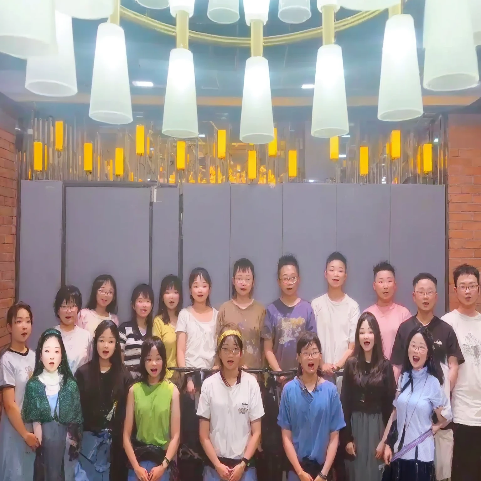 there are many people standing together in a room with lights, group photo, anime, happy