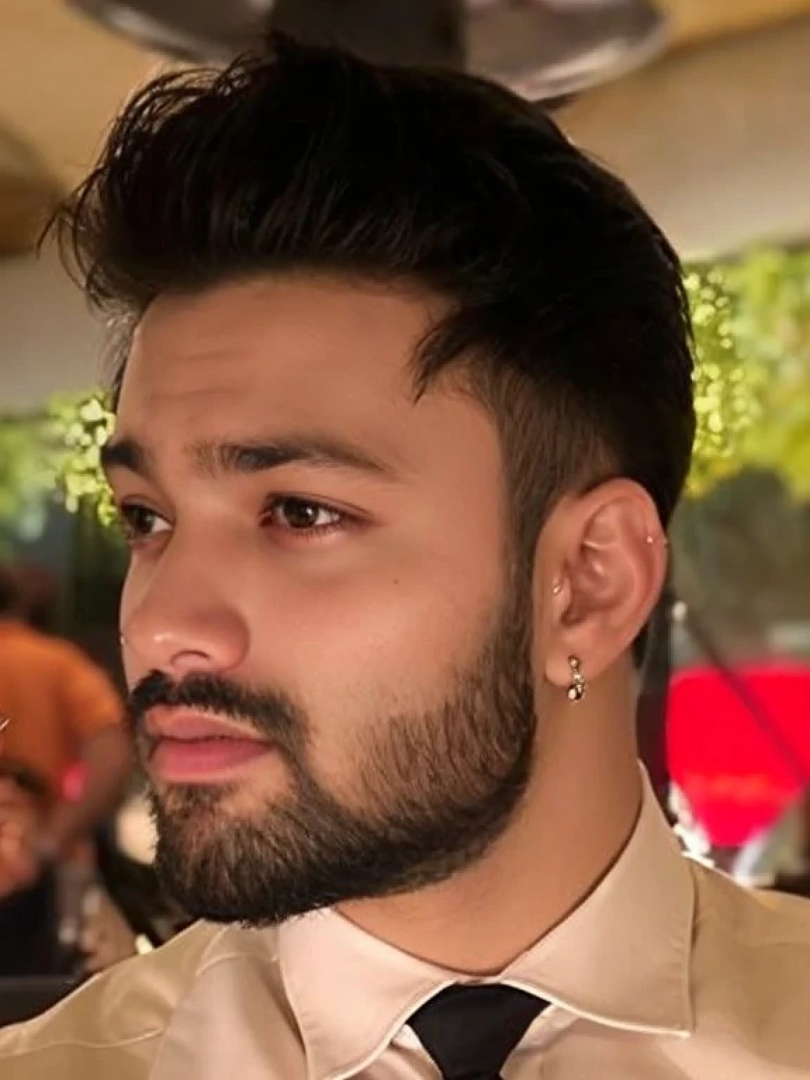 A beautiful young bearded man with highly detailed skin.black hair.