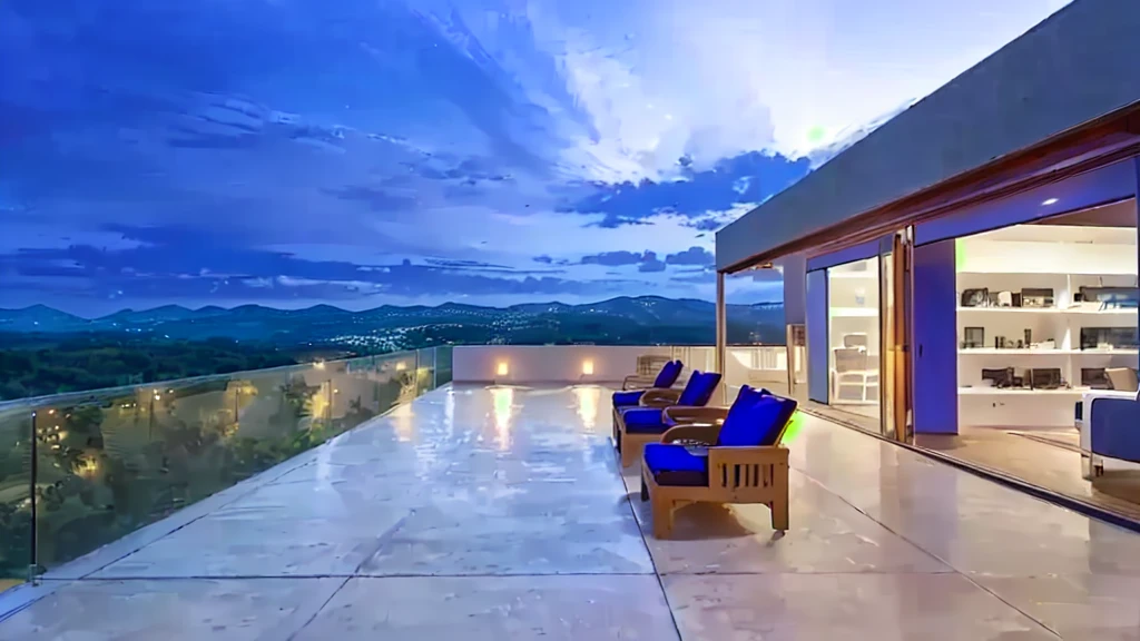 view of a patio with table and chairs overlooking a mountain, wide sight, contemporary masterpiece, paradise in the background, panoramic view at night, sit by the pool, beautiful view, architectural photo, beautiful and spectacular twilight, expansive cinematic vision, sunset view, Beautiful terrace, Incredible view, nice view, time to relax. good view