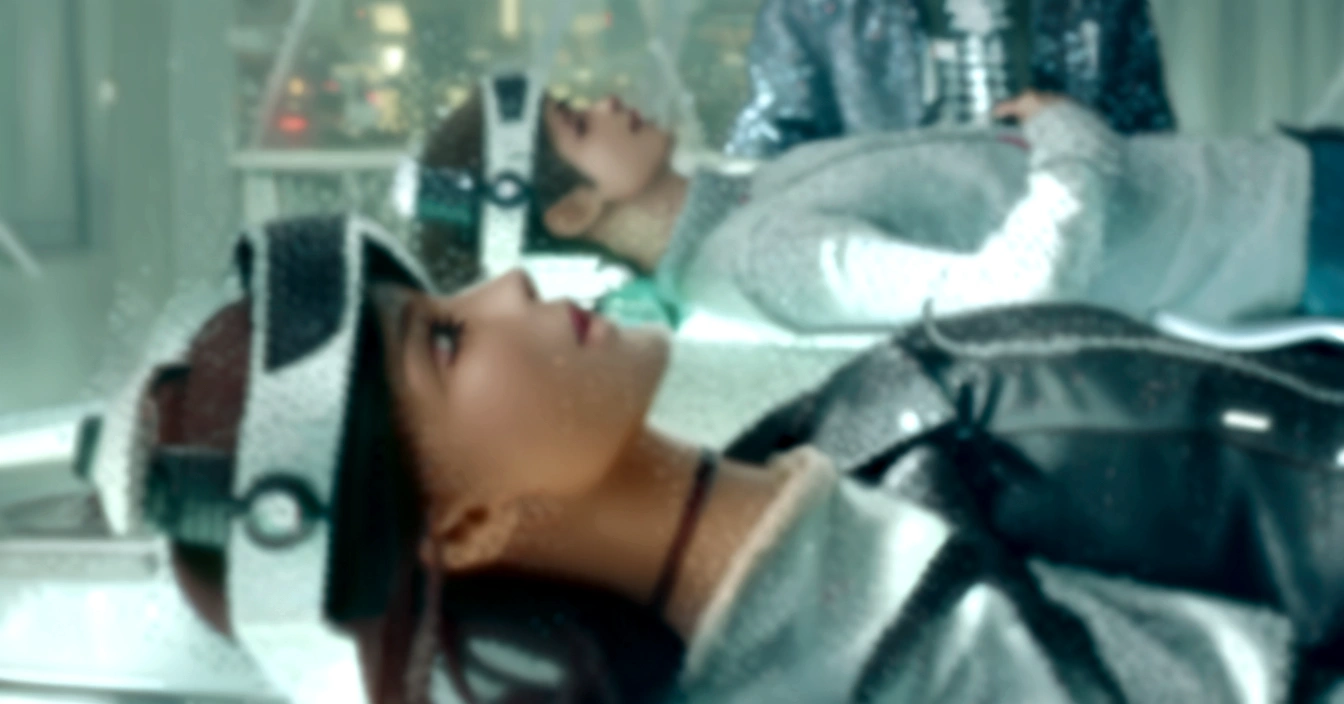 there is a woman laying on a bed with a pair of headphones on, still from a music video, music video, ariana grande in star wars, waist - up, performing a music video, fashionable, daft punk style, zoe kravitz futuristic astronaut, movie still of a cool cyborg, lying down, brilliant, kpop, youtube video screenshot, screenshot from a movie, unfortunate