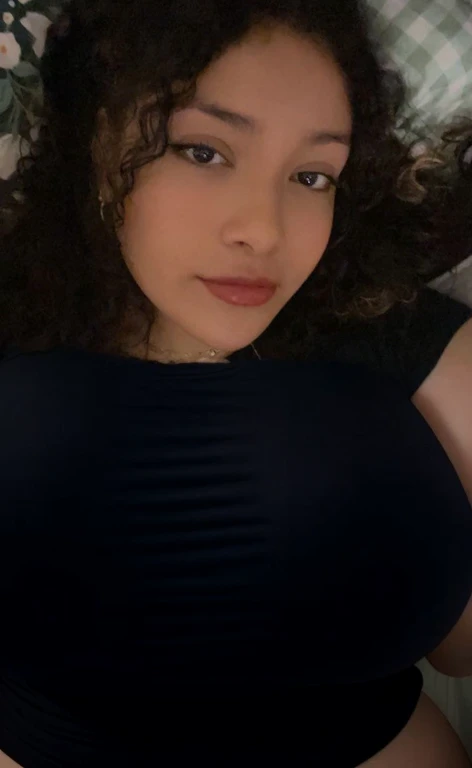 there is a woman laying in bed with a cell phone, taken in the early 2020s, profile image, around 1 , selfie of a young woman, 18 years old, alanis guillen, headshot profile picture, profile pic, 30 years old woman, 3 0 years old woman, her face framed with curls, Big tits, huge tits, no clothes, sexy, cute, minimal clothes, thick, bbw, chubby stomach, thick nipples, nipple piercings, large areola, hard nipples, piercing through shirt, nipples hard through shirt, busty, major cleavage, naked, ripping through top, spilling over sides, bra too tight, giant tits, extra wide hips, upper body zoom in, showing off huge tits, fat stomach, see through top, fat bbw, large areola showing, major cleavage, latina, down to stomach, wide hips, sexy, upper body zoom, thick arm, showing off , top half only, showing only upper, only a bra, showing off cleavage, naked huge tits