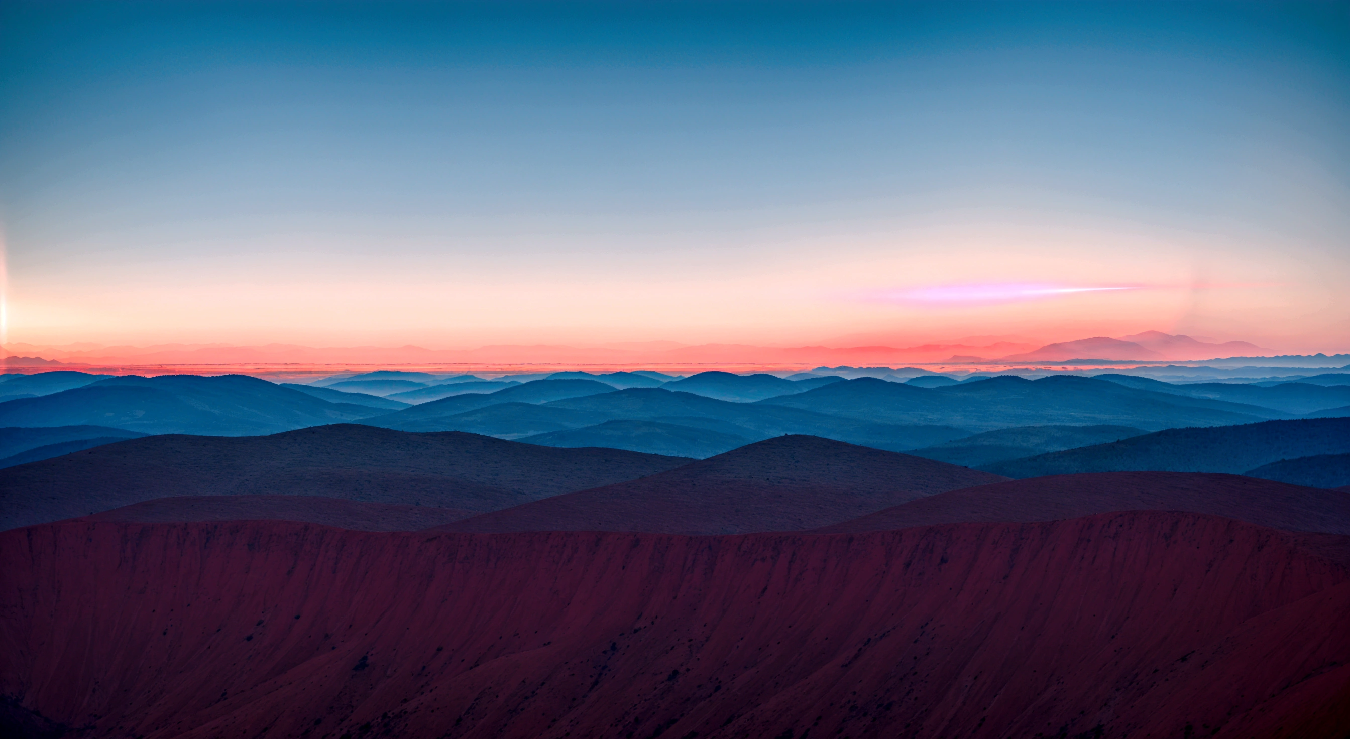 a vibrant red beam of light splitting the distant sky and a flat horizon, between the skyline and the even mountain range, with a dramatic atmosphere, a shine red line