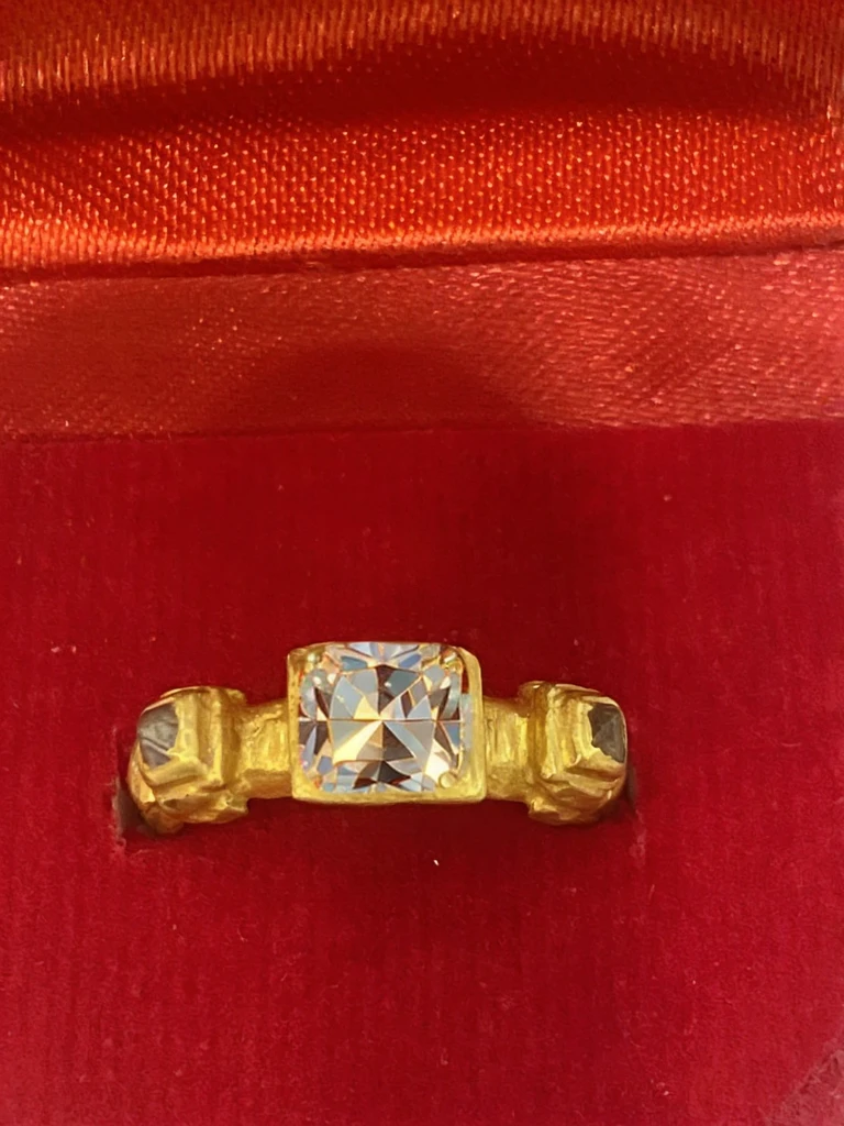 a square polished diamond, setting seamless to the gold ring, high detail, photorealism