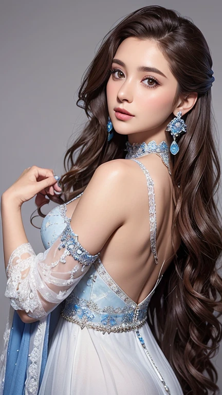 Woman with long, wavy brown hair wearing a low-cut, white and blue dress adorned with silver embellishments and a lace choker. She is also wearing dangling, ornate earrings. The background is a plain light grey.