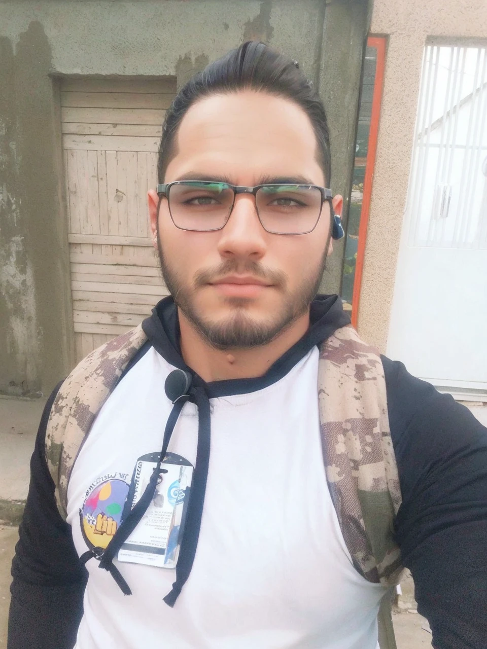 Straight, slanted dark hair, beard shadow enhance facial details