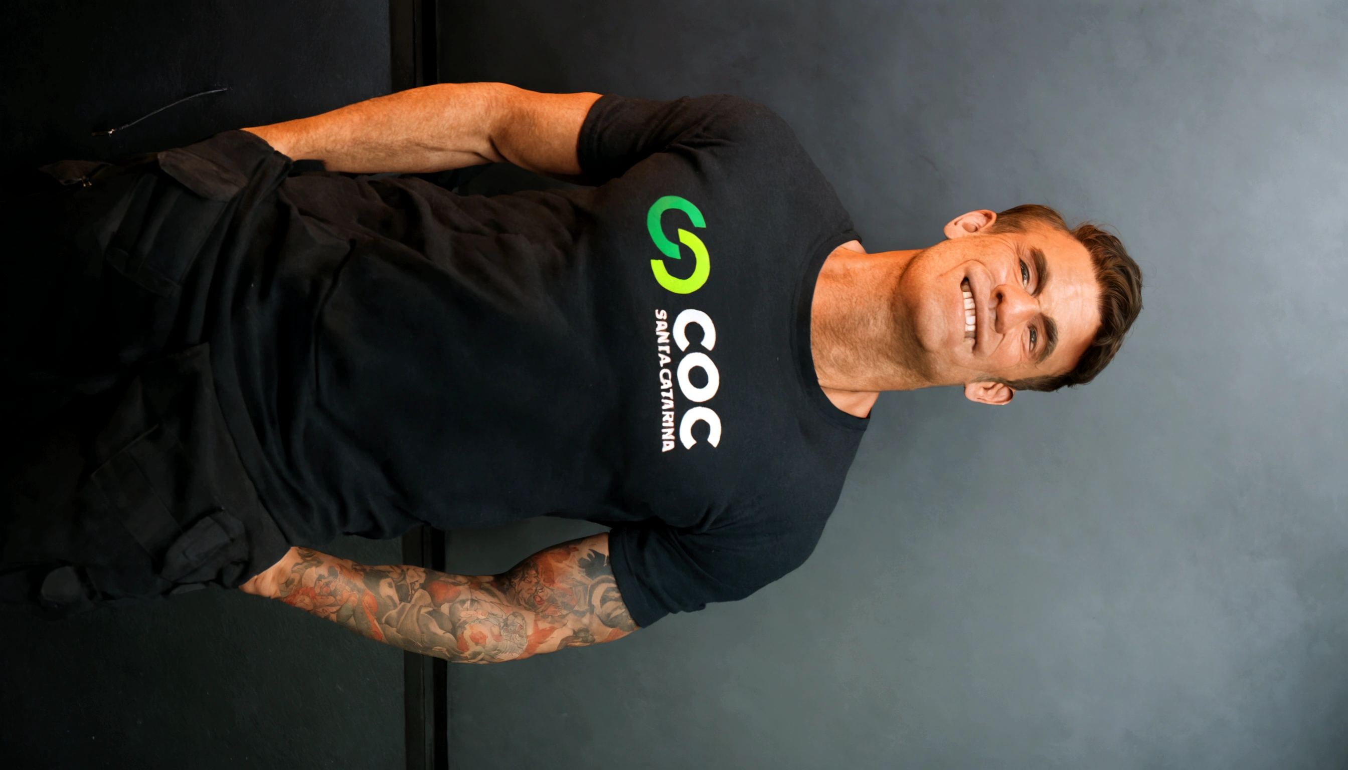 there is a man with tattoos standing in a room, profile image, Chris Cunninham, Casey Cooke, sascha schneider, caio santos, daniel dociu, commercial shot, Jamie Coreth, he is wearing a black t-shirt, official product photo, Nick Silva, full body Greg Rutkowski, photo taken in 2018, 3 5 years old