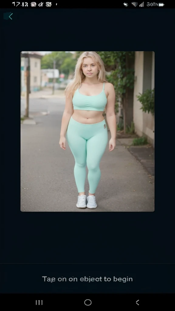 A girl wearing mint green leggings and taking them off to show that shes wearing a swimming costume underneath shes got blonde hair and blue eyes