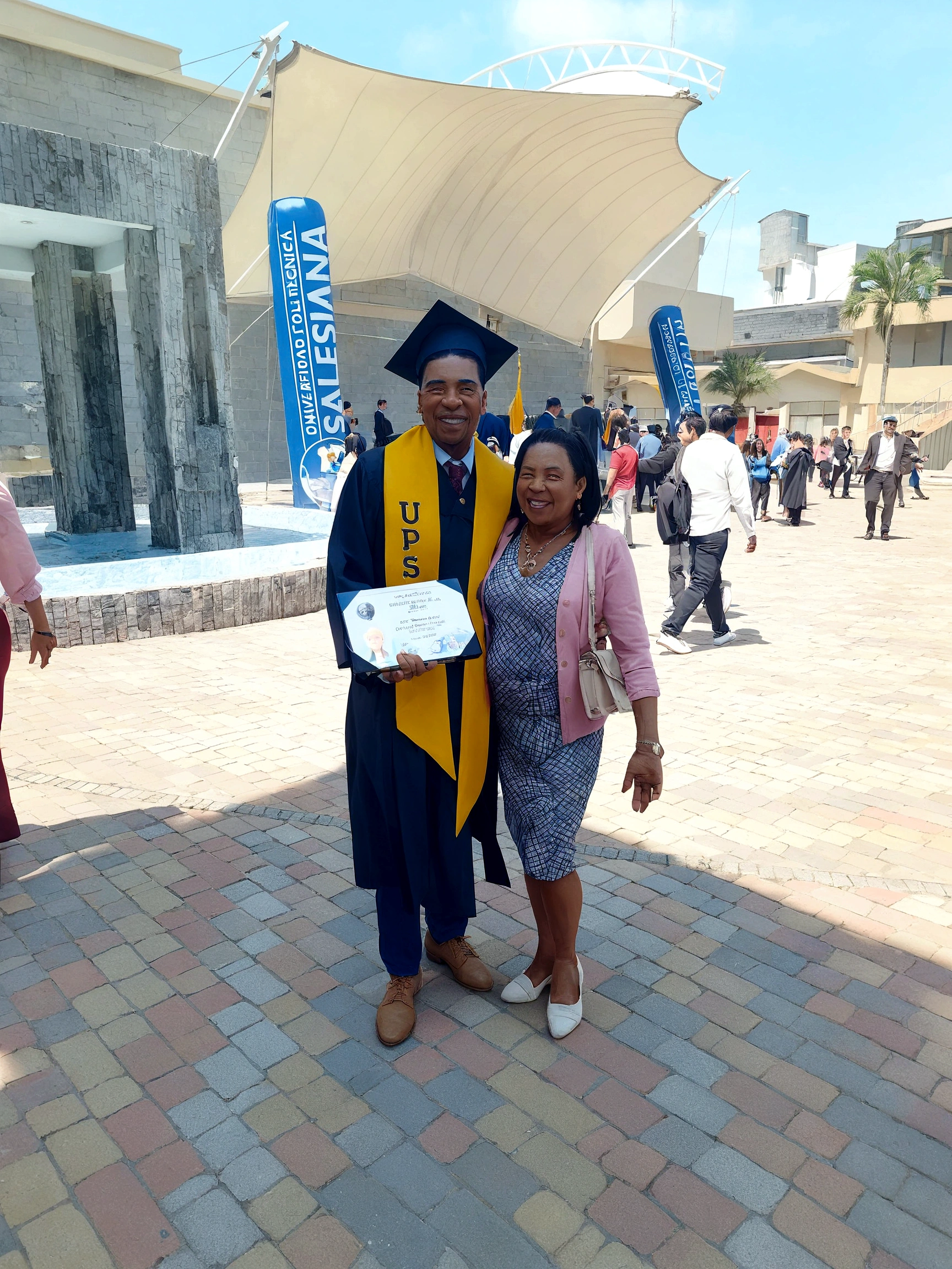 There are a man and a woman standing together in front of a building, album photo, Postgraduate, graduation photo, by Milton Menasco, 2 0 1 9, 2019, edited, photo taken in 2 0 2 0, wearing an academic gown, Lt. Bernie D'Andrea, George Pemba, taken with the best dlsr camera