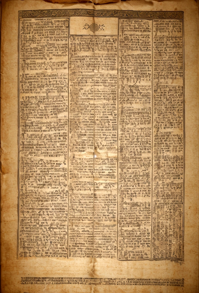 Image of an ancient scroll, with the text of Malachi 2:11 featured