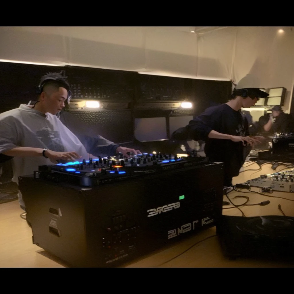 there is a man that is standing in front of a dj's equipment, djing with dj turntables, dj set, dj, shigeto hirai yuya, music being played, dj at a , shigeto koyama, hidari and vlop, smooth in _ the background, live performance, profile pic, jason chan and gilles beloeil