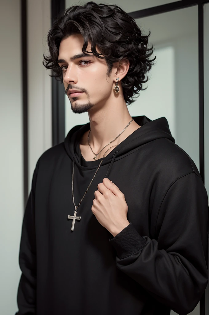 Tall dark-haired boy, black sweatshirt, cross earring, black curlyhair, and brown eyes and a goatee.