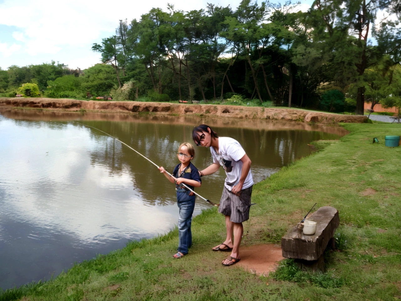 Man wearing glasses esinating a blond fishing. The background is a pond with a lawn and trees