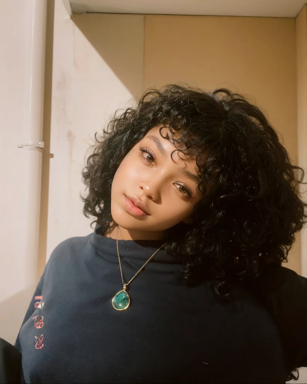 A black woman with her eyes downcast and her head slightly to the side with her hair tossed