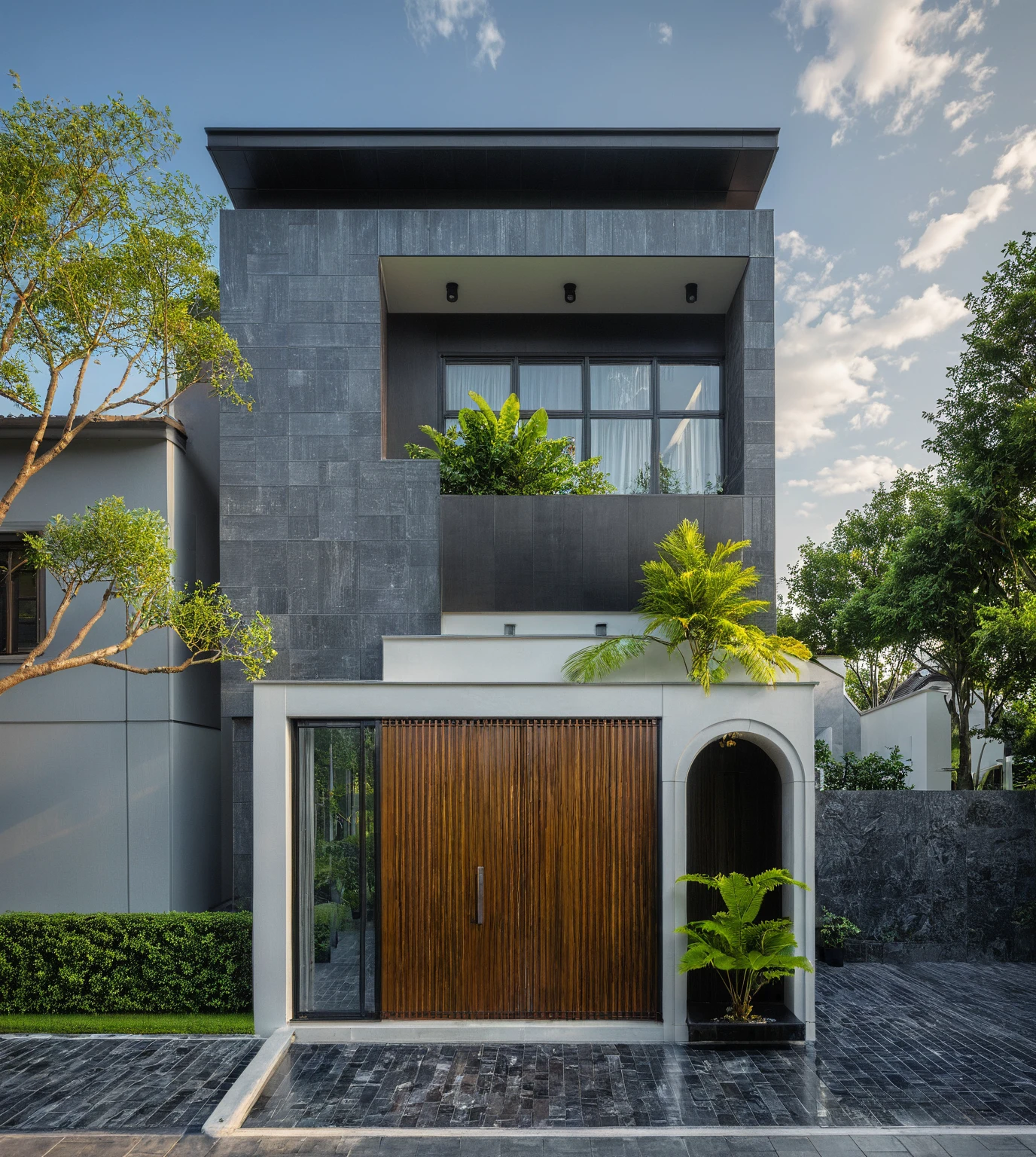 modern villa on street, (daylight), tropical tree, (slope roof, black tiled roof:1.2), vivid color, streetcapes, nice sky, grey tone, large glass door, warm interior lighting, modern material, best quality, ultra realistic, masterpiece, 17ArchiAI_XL_VL-v1