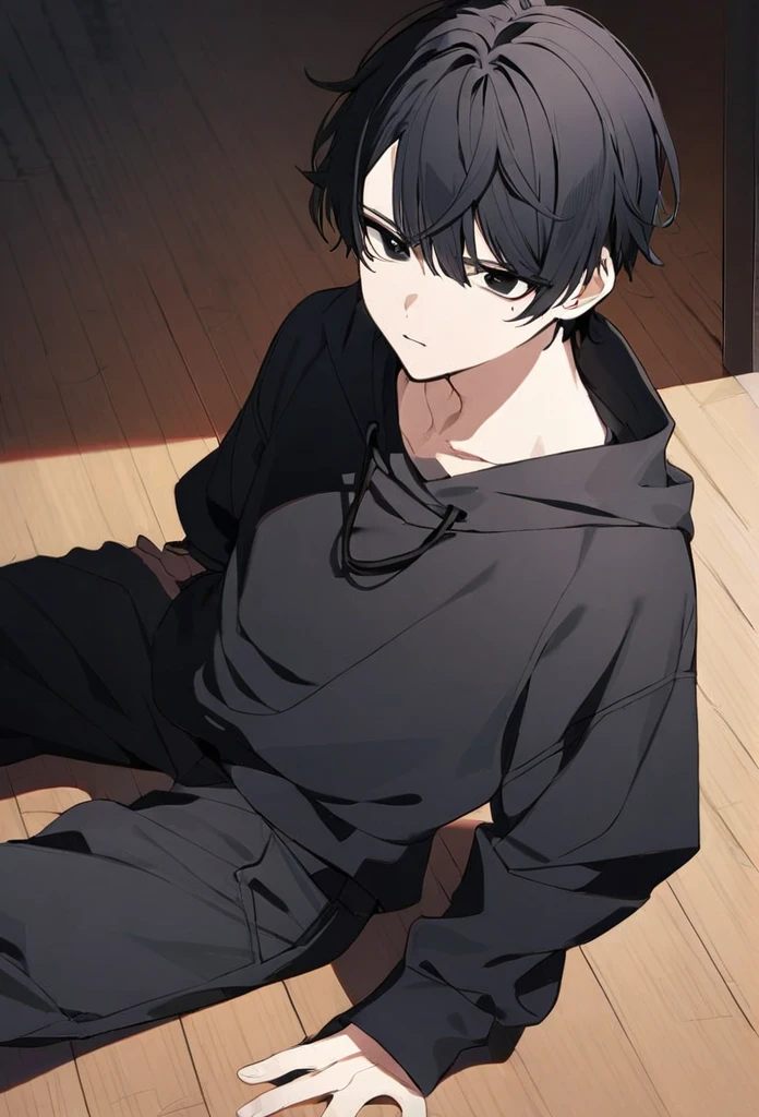 guy, black hair, very short hair, black eyes, black sweatshirt, black pants, sitting on the floor 