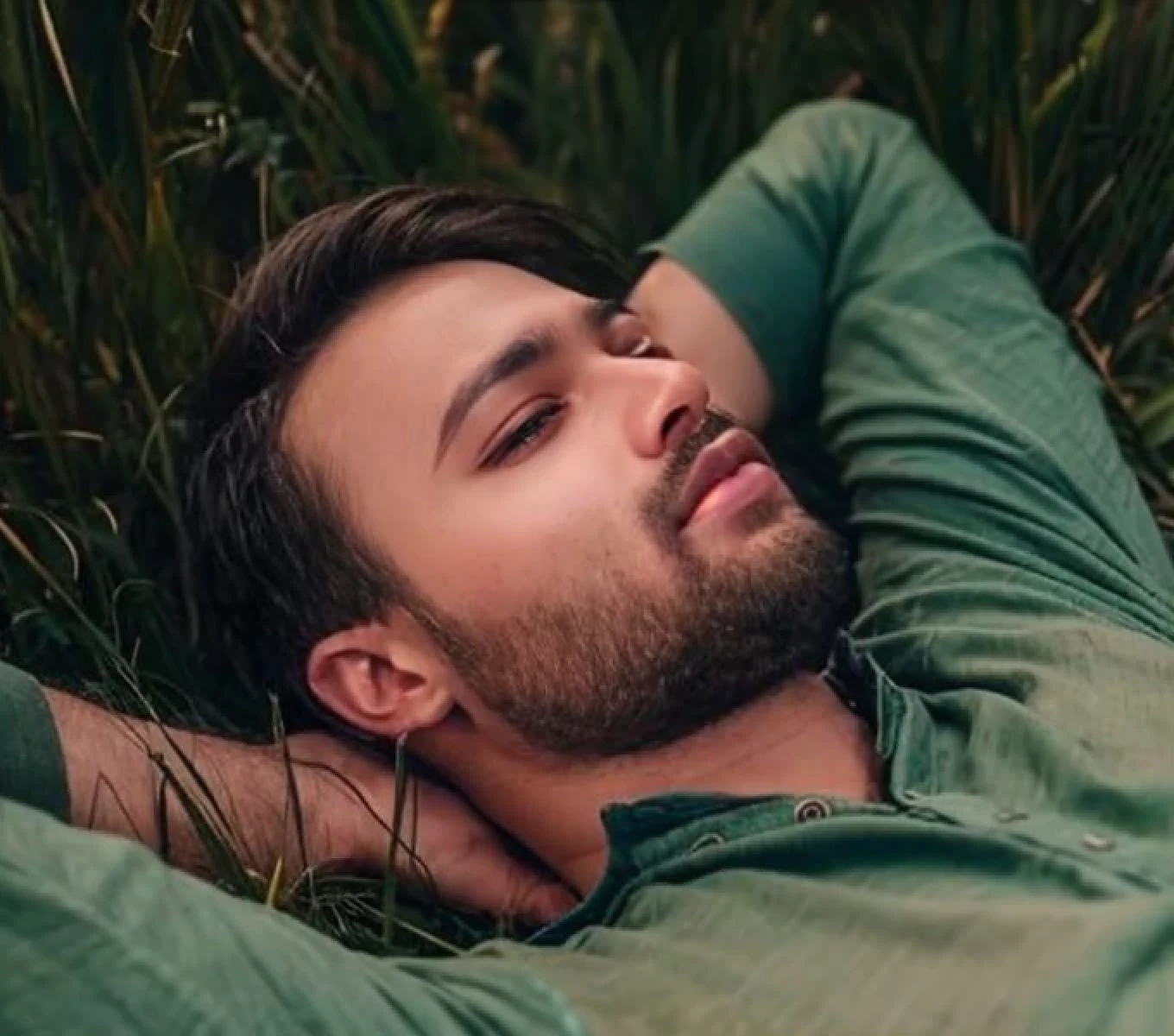 A beautiful young bearded man with highly detailed skin.black hair.