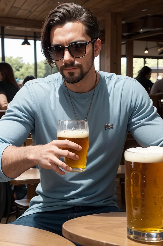 There is a man sitting at the table drinking a beer.