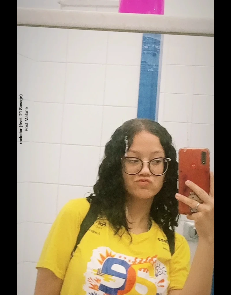 there is a woman taking a selfie in the mirror, wearing a modern yellow tshirt, 18 years old, Yellow themed wavy hair, snapchat photo, taken at the beginning of 2020, selfie of a young woman, in the bathroom, profile image, with long hair, 1 6 , selfie taken directly at angle, wearing yellow top, profile photo and wearing a bikini with only the red bottom, thick feathers and big ass