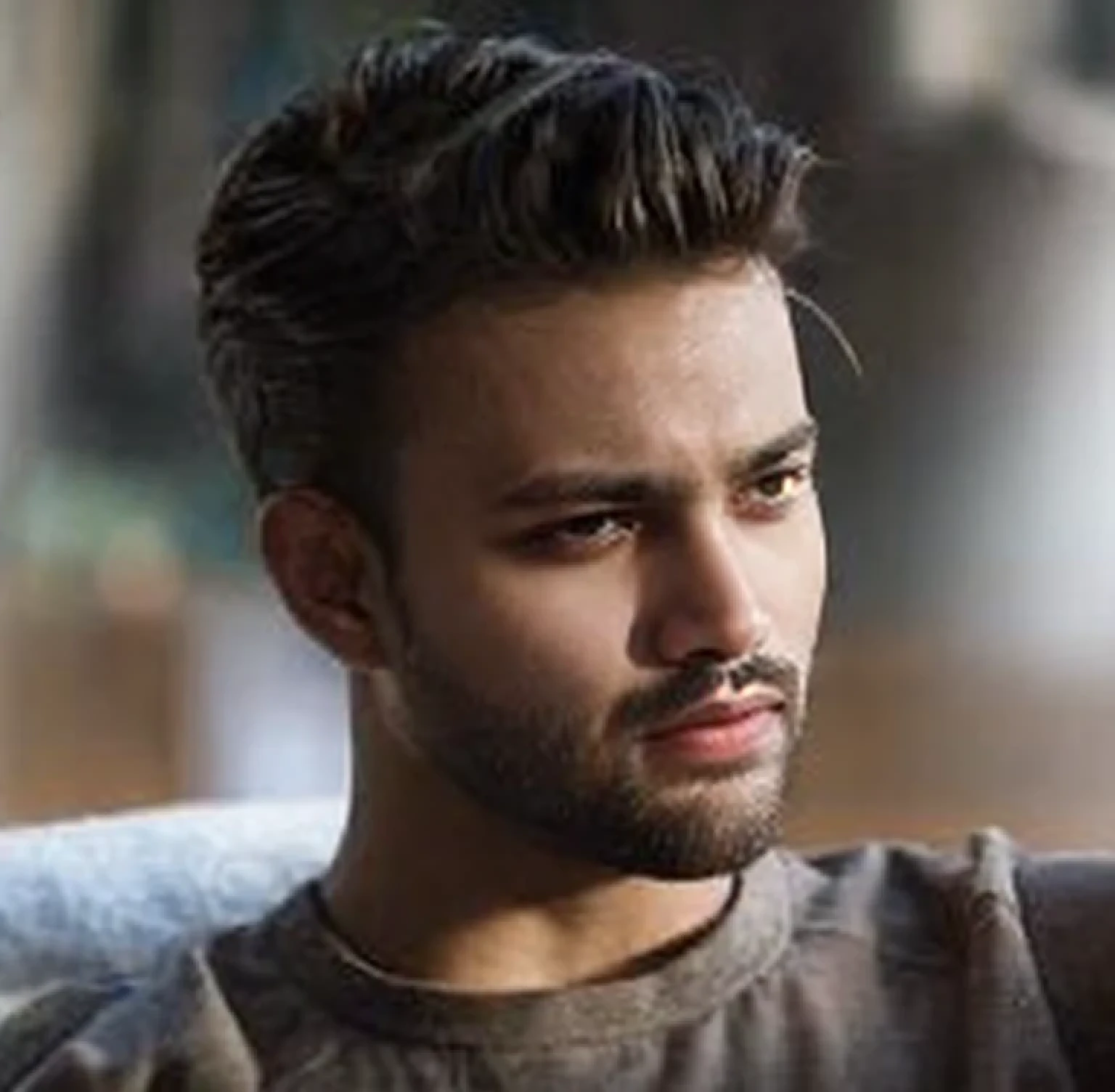 A beautiful young bearded man with highly detailed skin.black hair.