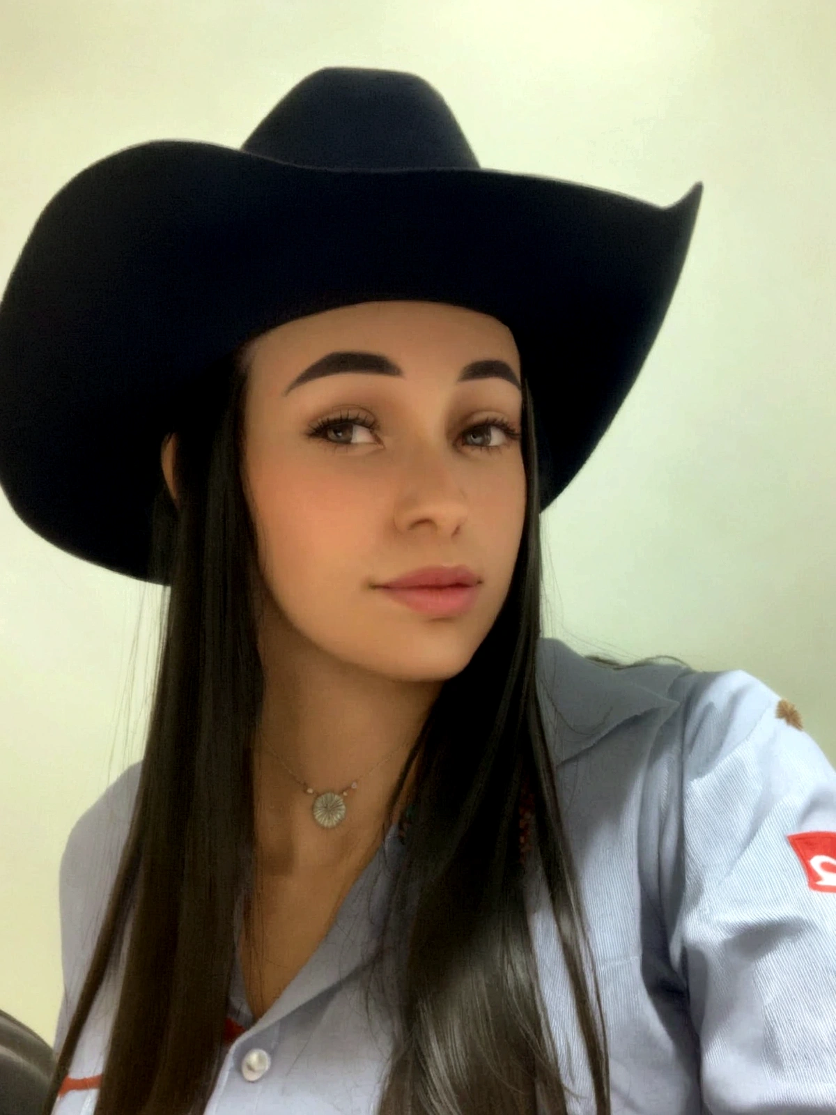 arafa woman wearing a black hat and a blue shirt, cowgirl, alanis guillen, profile image, cowgirl, taken at the beginning of 2020, profile picture with headshot, lorena avarez, western cowgirl, 21 years old, Wearing a cowboy hat, 18 years old, 22 years old, fernanda suarez
