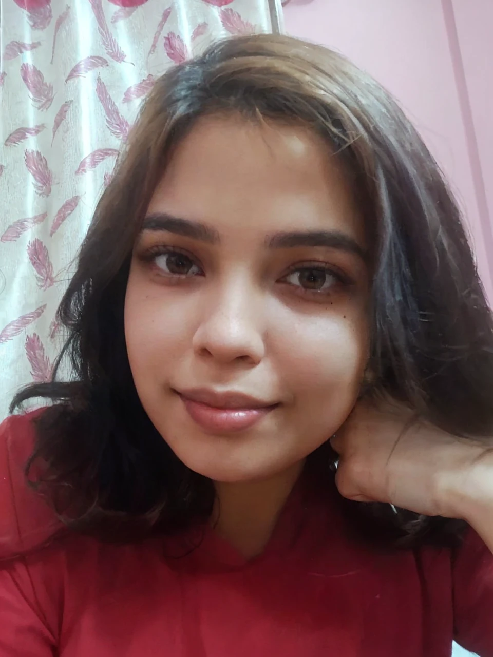 Pretty, indoor, brunette, mole on left side chin, smilling, sharp nose, plump lips, almond eyes, fair skin