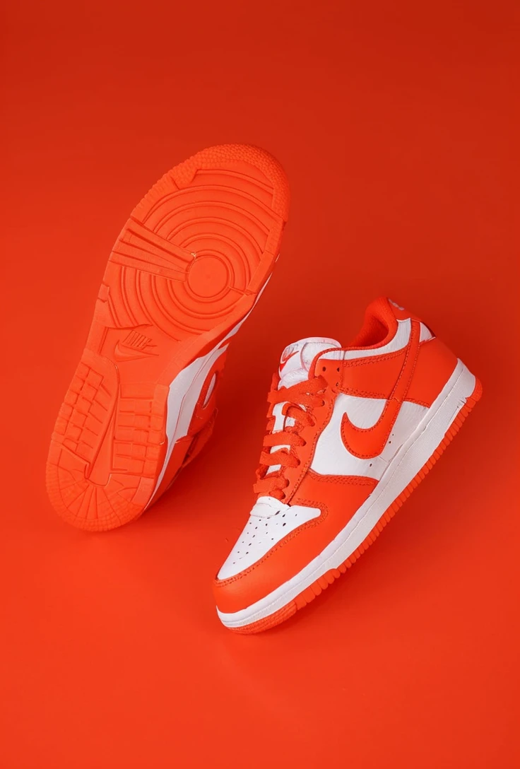 A detailed image of a Nike Air Force sneaker, side view, tilted with the back part elevated and the front tip touching the ground, iconic white leather, perforated toe box, Nike swoosh logo, thick rubber sole, detailed stitching, high-resolution, photorealistic, background: 100% white