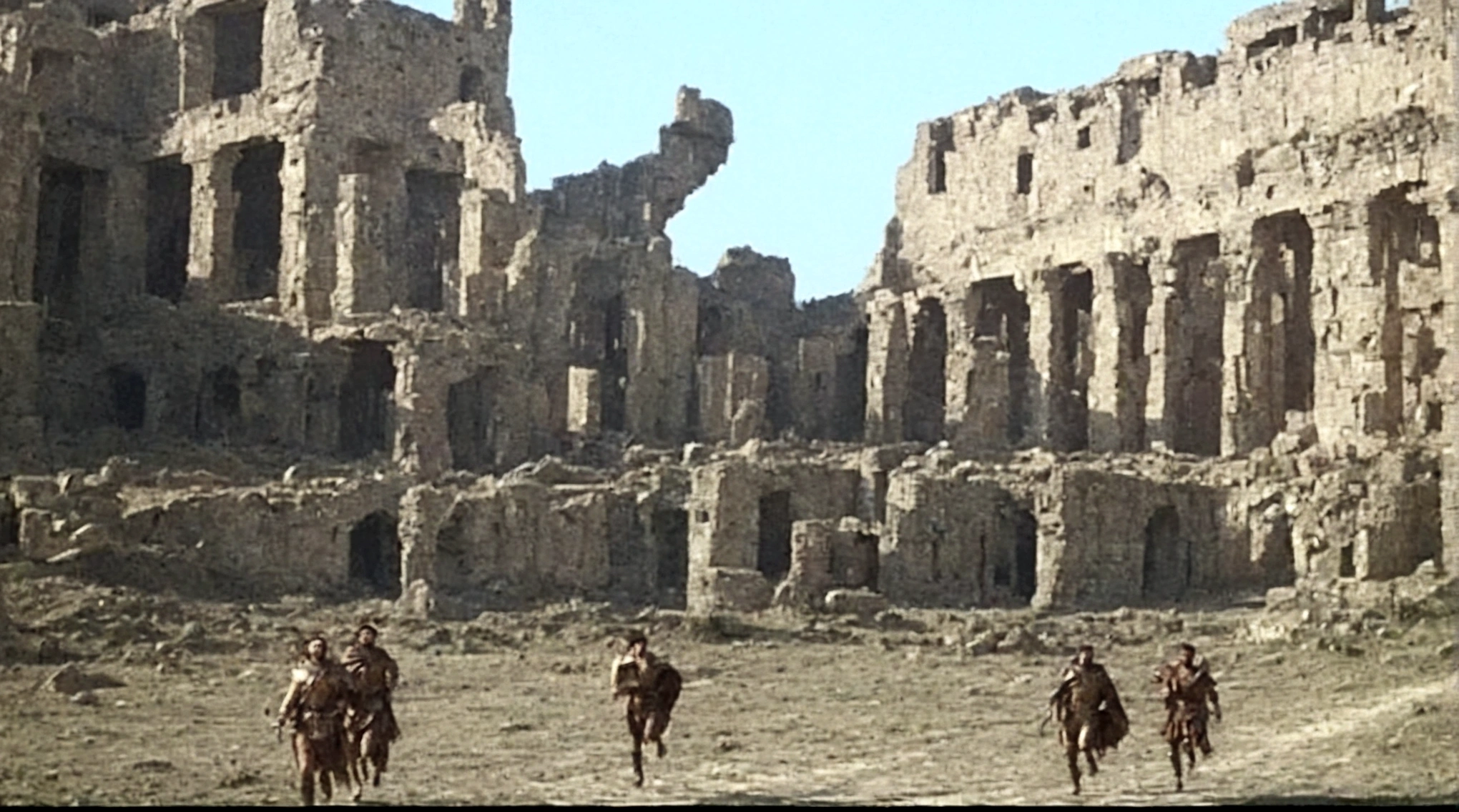 grainy old footage, 35mm vintage, frightened 18th century explorers running from two giant-spartan soldiers among ancient ruins