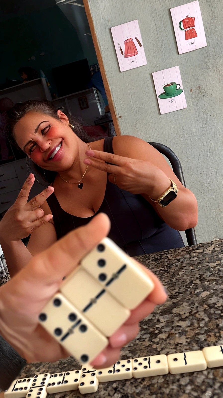 there are two people playing dominoes with a woman, 30-year-old woman from cuba, by Daniel Lieske, taking control while smiling, by Matteo Pérez, playing board games, carla ortiz, powder Nándor Katona, Playing games, by Judith Gutierrez, by Amélia Peláez, por Joseph Pisani, smiling happily at the camera