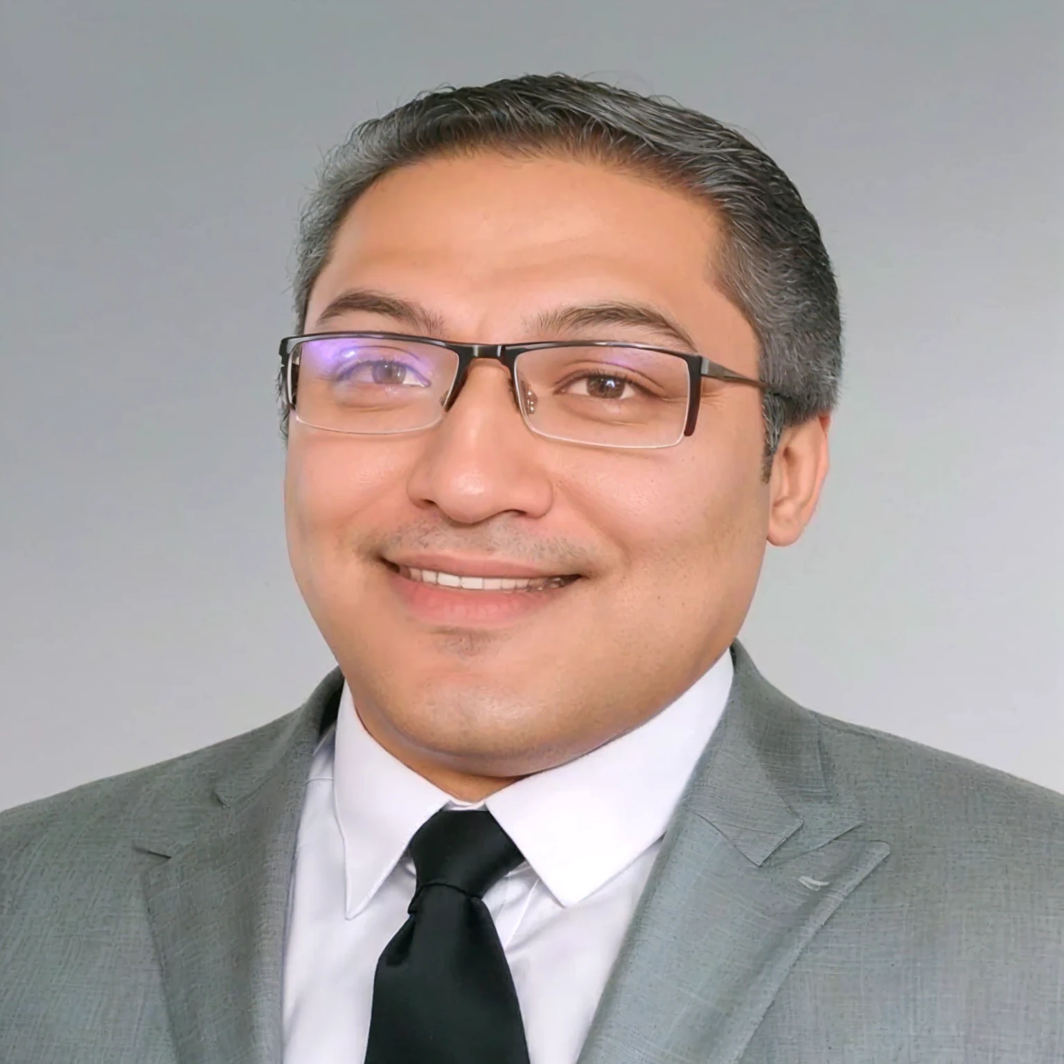 Smiling man in suit and tie with glasses and white shirt, accession of henry, mohamed chahín, Carlos Ortega Elizalde, Sam Nassour, mario martinez, Ted Nasmit, richard taddei, Ahmad Merhab, victor maristane, Amr El Shamy, Jama Jurabaev, professional photo, luiz scanuela, Andres Rios, herald ortega
