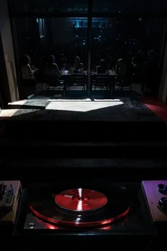 include a large tv screen showing the room that the red cd is in and showing an outline of a man shadow figure standing behind the cd player