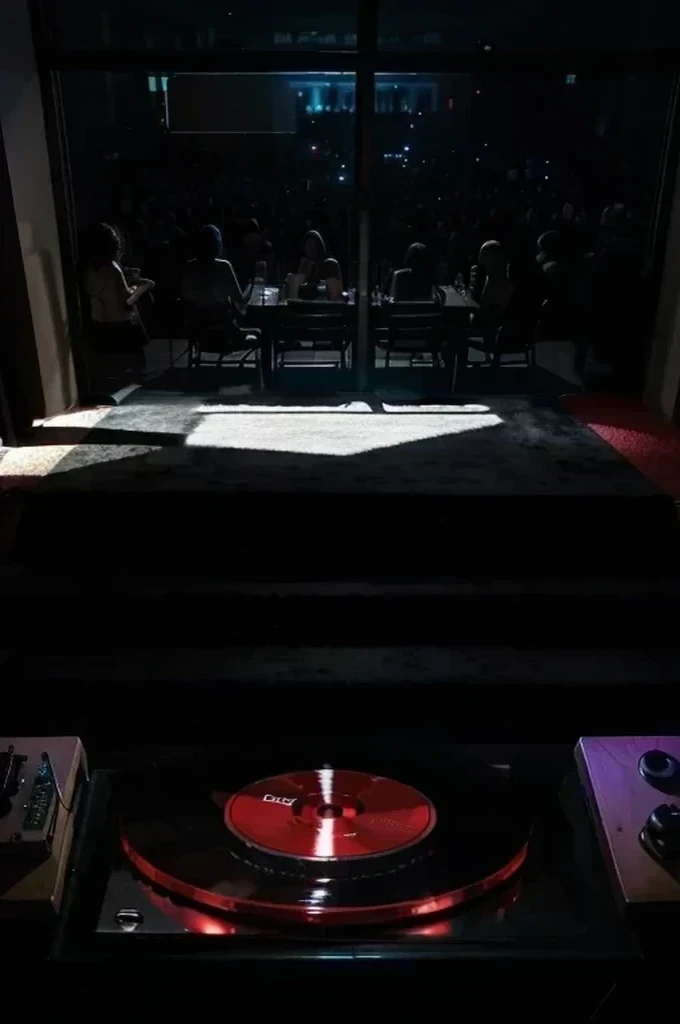 include a large tv screen showing the room that the red cd is in and showing an outline of a man shadow figure standing behind the cd player