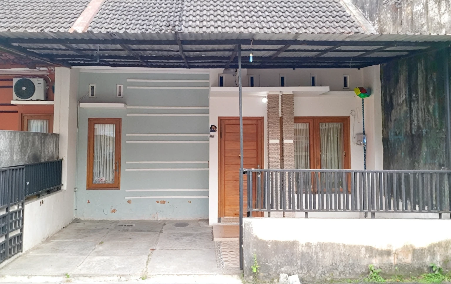 Minimalist house, doorway of a house with a metal fence and a wooden door, frontview, front side, front view, arsitektur nusantara, front side view, front-view, exterior view, my home, outside view, complete house, one house, frontal picture, facing front, front symetrical, front, front facing, front perspective