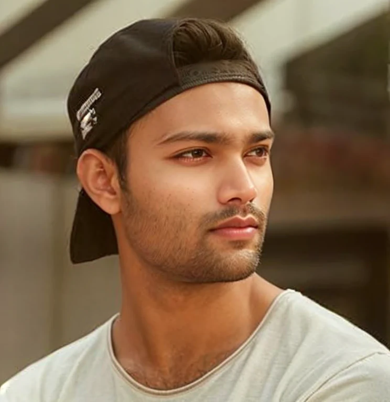 A beautiful young bearded man with highly detailed skin.black hair.happy emotion