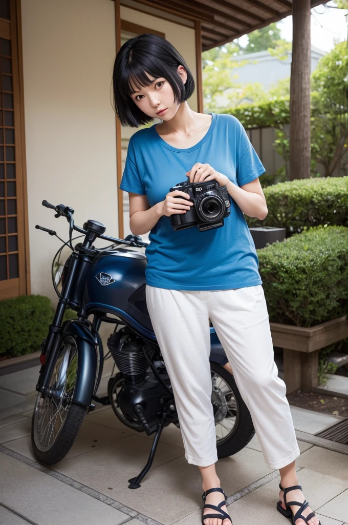 in pants and a blue t-shirt and with short black hair and sandals, she has to be Japanese and has to hold an old camera