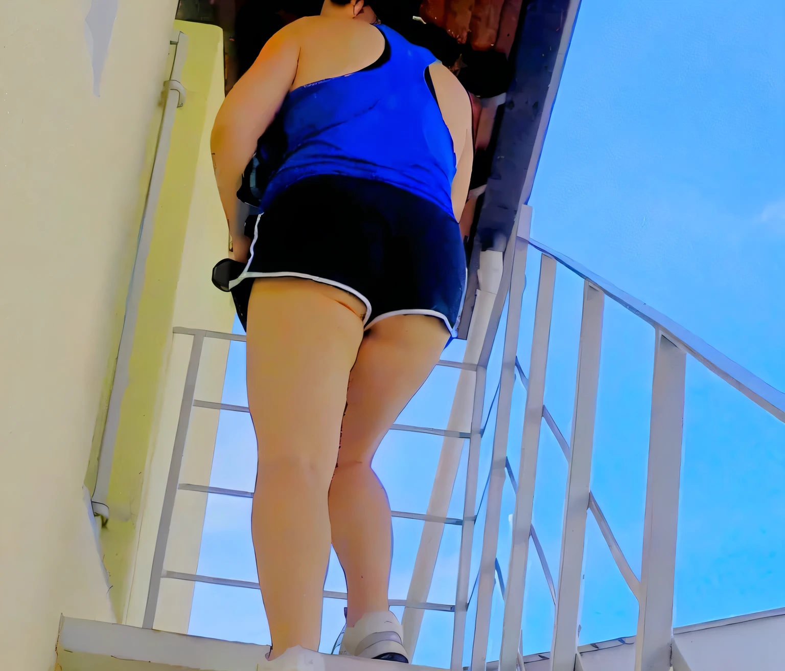 araffed woman climbing up a set of stairs with a backpack, coming down the stairs, in shorts, back - shot, side shot, low - angle shot from behind, rear-shot, giantess shot, shot from the back, close-up shot from behind, seen from the back, backshot, uhd candid photo of dirty, long shot from back