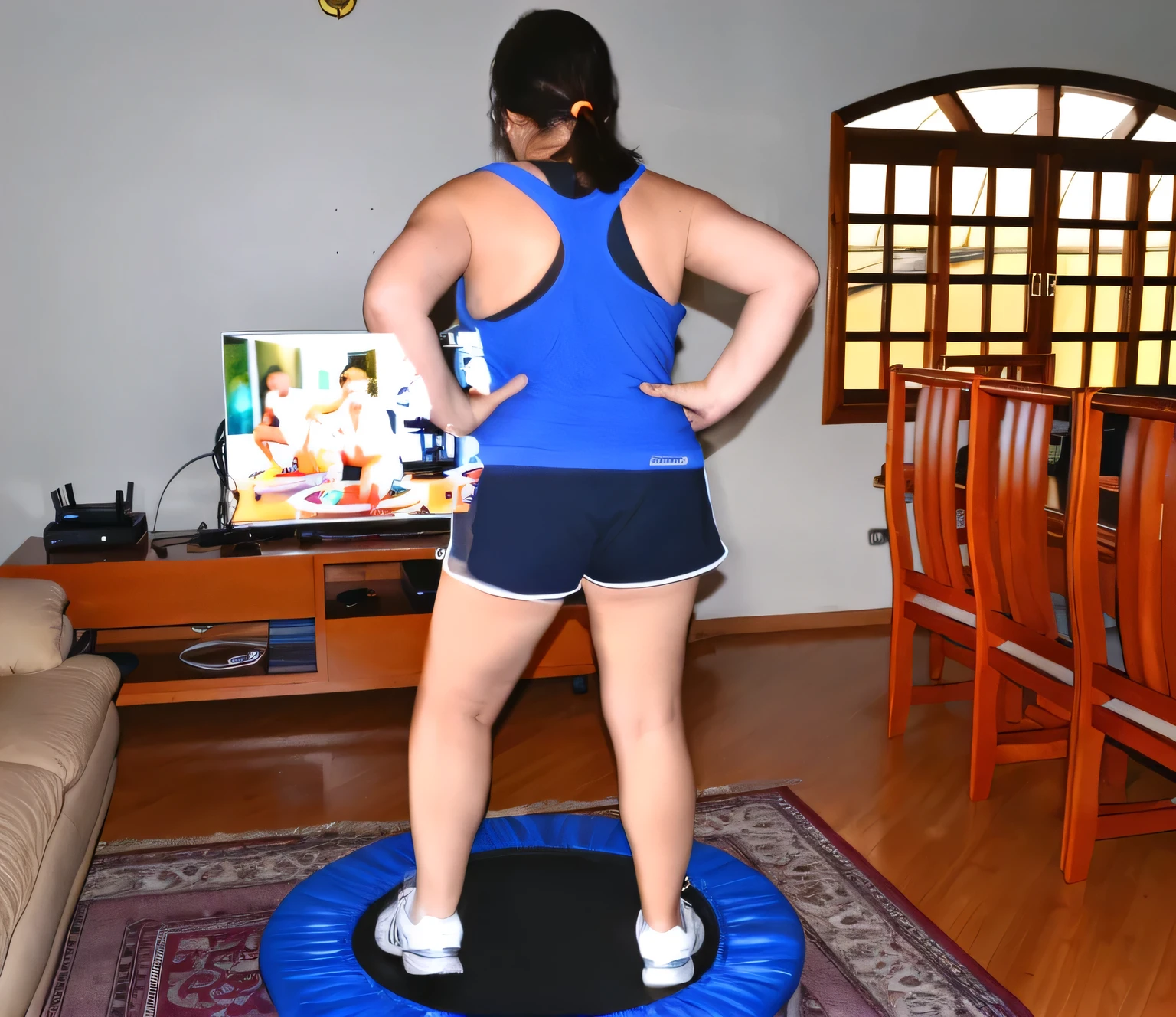 there is a woman standing on a trampol in a living room, back - shot, bouncing, fernanda suarez, caroline gariba, working out, backshot, rear-shot, indoor, back shot, full body wide shot, centered full body rear-shot, indoor shot, cottagecore!! fitness body, medium shot taken from behind