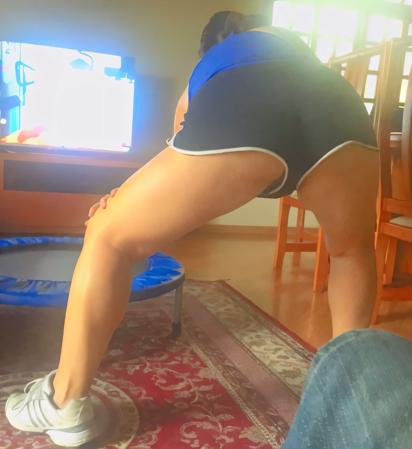 araffed woman in shorts bending over to look at a television, 🐎🍑, thighs!!!!!!, exposed thighs!!!, shot from the back, view from the back, photo taken from behind, bending over, back - shot, indoor shot, view from behind, photo from behind, bottom shot, rear-shot, long shot from back, leg and thigh shot