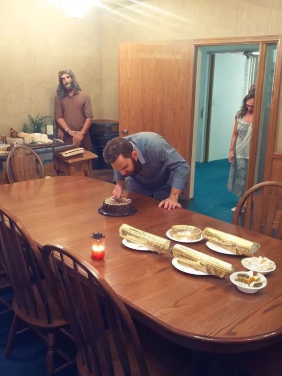 Keep the image EXACTLY as is, unchanged, except add: a photorealistic Jesus, slightly larger than life, behind the man blowing out the candle in the photo. Jesus should be touching the man's back supportively.