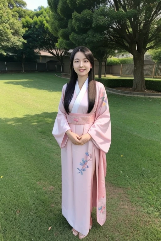 A young asian woman with long dark hair wearing a pink hanfu, smiling and posing outdoors in a grassy field with a blue sky in the background
